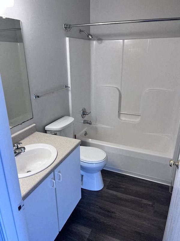 a bathroom with a toilet and a sink and a tub at Mason Street Townhomes, Grand Rapids, Michigan