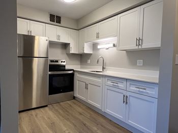 Kitchen with white cabinets and stainless steel appliances