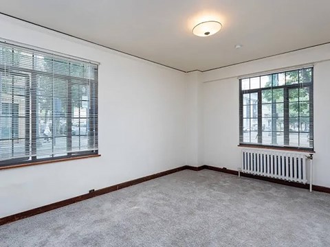 Carpeted floor, a window with blinds, and a radiator at The Lafayette, Portland, OR, Oregon , 97205
