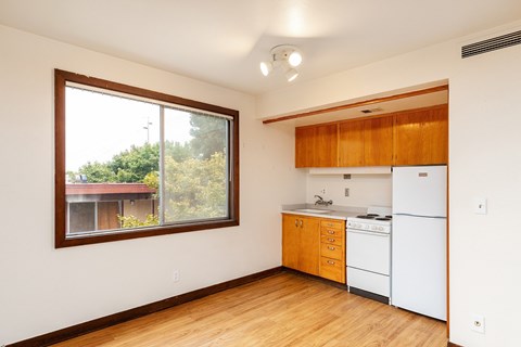 A kitchen with wooden cabinets and a white refrigerator at Julie Ann, Portland, OR, Oregon