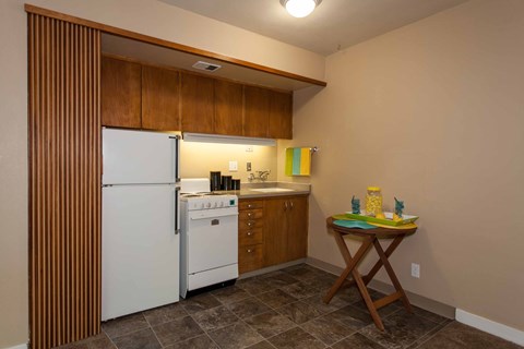 Bright Kitchen with a white refrigerator, wooden cabinets, and a table at Julie Ann, Portland, OR, Oregon