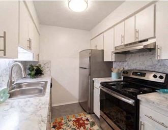 a kitchen with a stove refrigerator and sink  at Ivanhoe Apartments, Ann Arbor, PA
