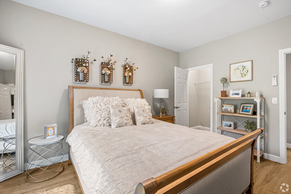 a bedroom with a large bed and a mirror at Lofts at 335, Stratford, Connecticut