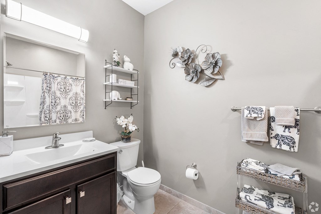 a bathroom with a sink toilet and a mirror at Lofts at 335, Connecticut