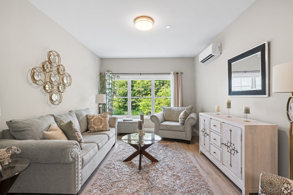 a living room with a couch and two chairs at Lofts at 335, Stratford, CT