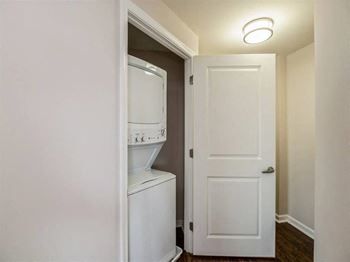 A white washing machine is in a small room.