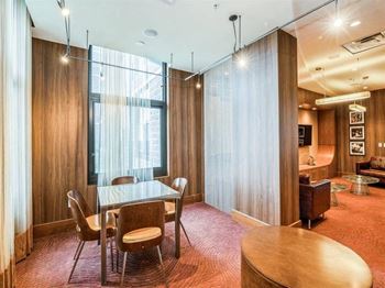 A conference room with a long table and chairs.