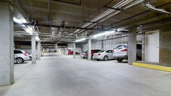 A parking garage with cars parked in it.