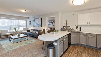 A modern kitchen with a dining table and a couch.