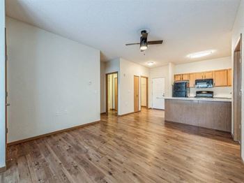 A room with wooden floors and a ceiling fan.