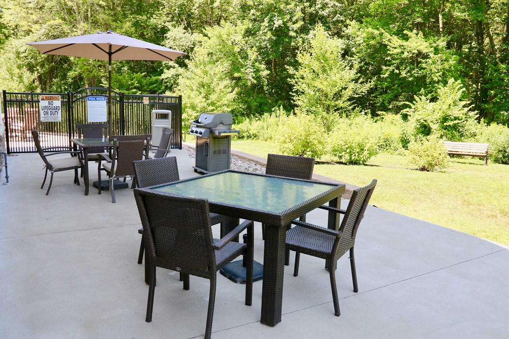 a patio with a table and chairs and an umbrella