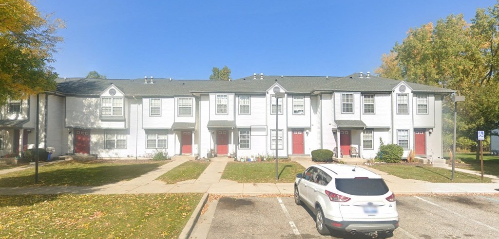 a white car parked in front of an apartment complex  at Mason Street Townhomes, Michigan, 49505