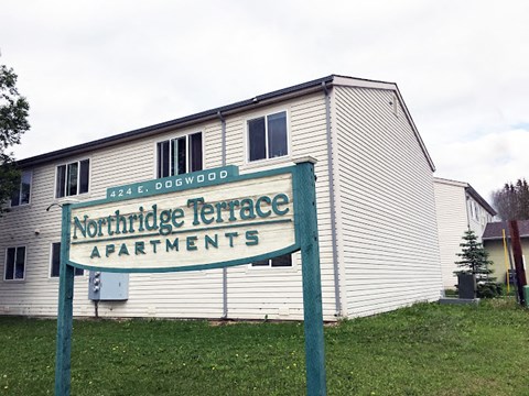 A sign for Northridge Terrace Apartments stands in front of a building.