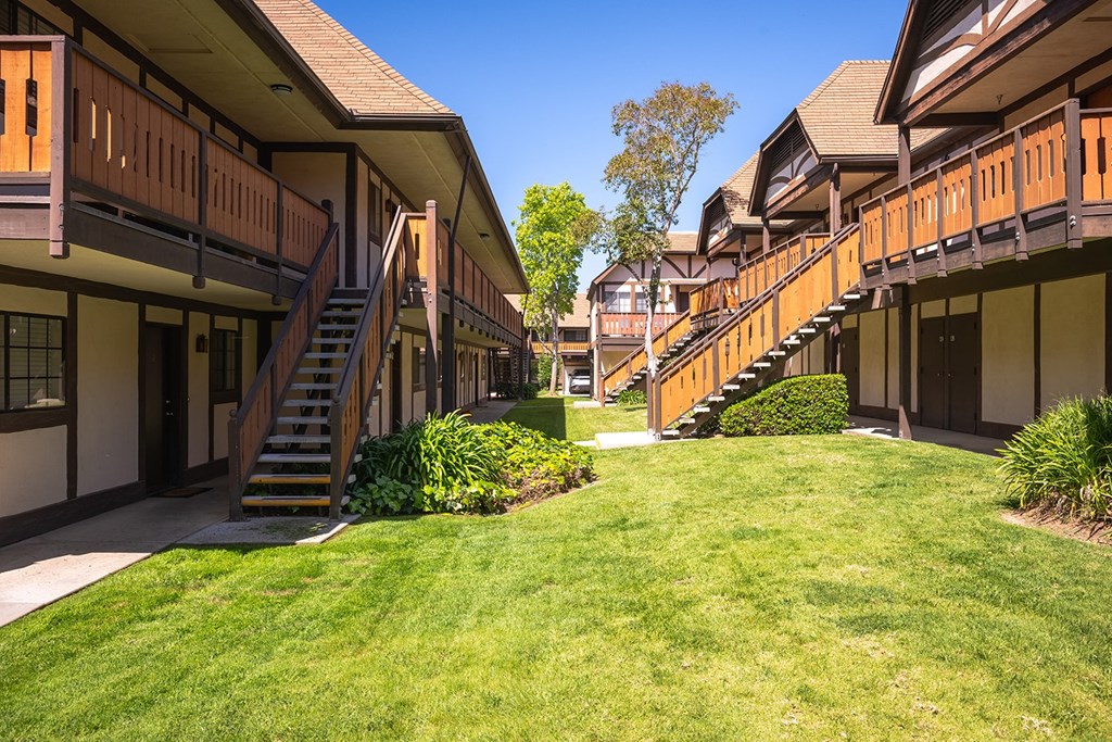apartment building with stairs and a grass yard at Oak Park Apartments, Solvang, California