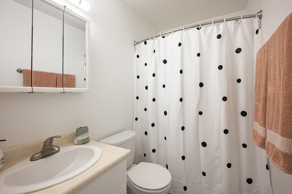 a bathroom with a shower and a sink and a toilet at Oak Park Apartments, California