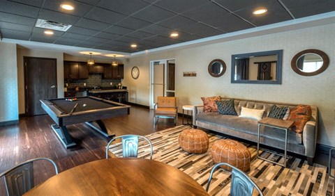 a living room with a pool table and a dining table