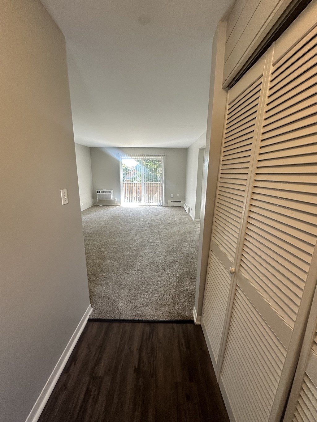 a view of a living room from a hallway with closet doors at River Oaks, North Aurora, IL, 60542