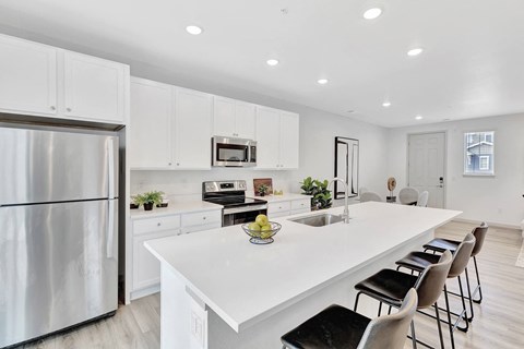 Kitchen with a white counter top and large island