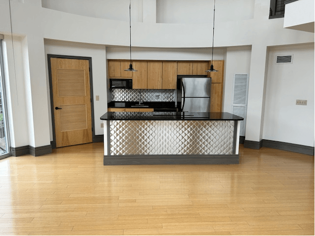 living room with a kitchen and a door