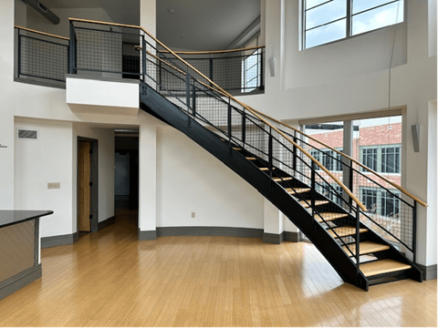 a staircase in with wood floors at The Flats at Southside