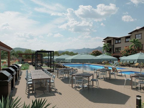 A poolside area with tables and chairs and umbrellas.