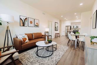 a living room with a couch coffee table and a kitchen in the background at Arrive Paso Robles, California, 93446