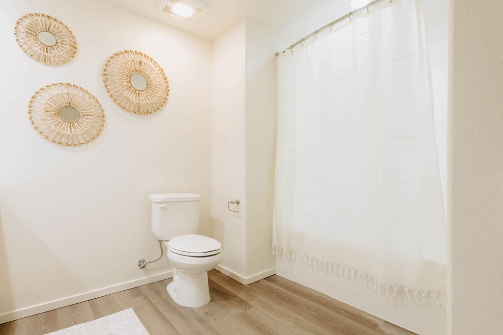 a bathroom with a white toilet and a white shower curtain  at Arrive Paso Robles, Paso Robles, CA
