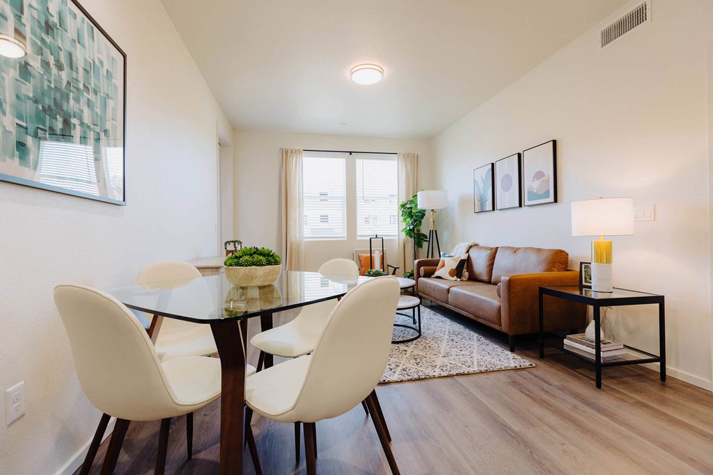 a living and dining room area with a glass table and white chairs at Arrive Paso Robles, Paso Robles, CA