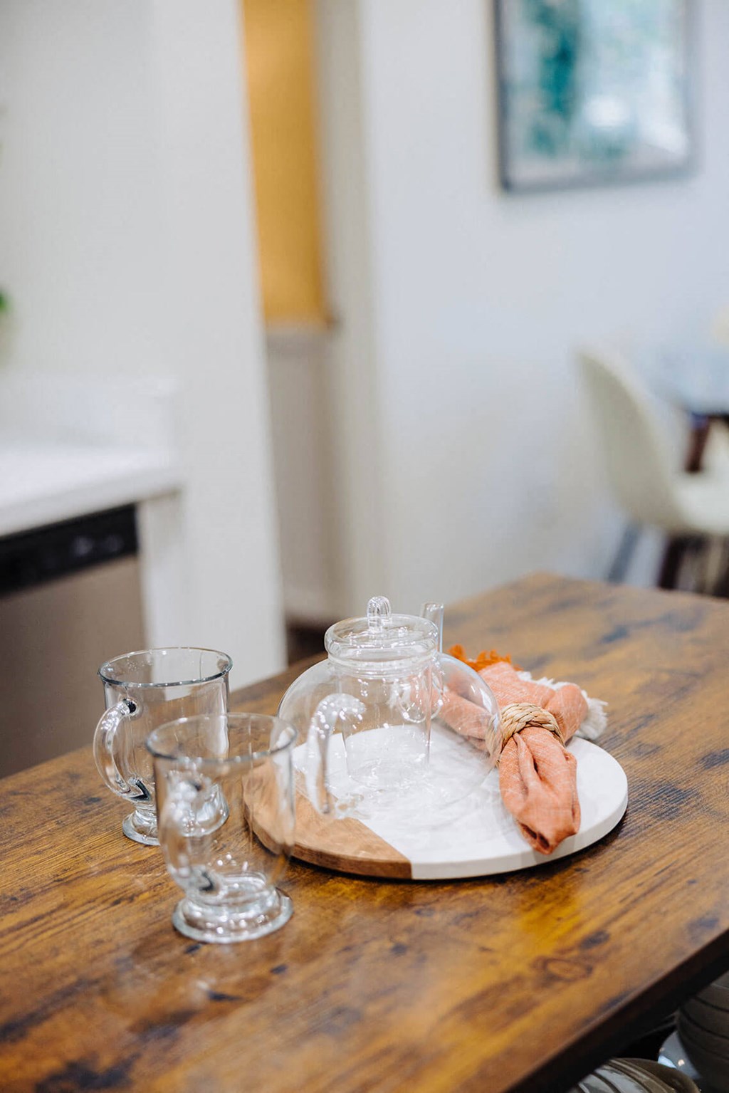 a wooden table with a plate and glasses on it at Arrive Paso Robles, California