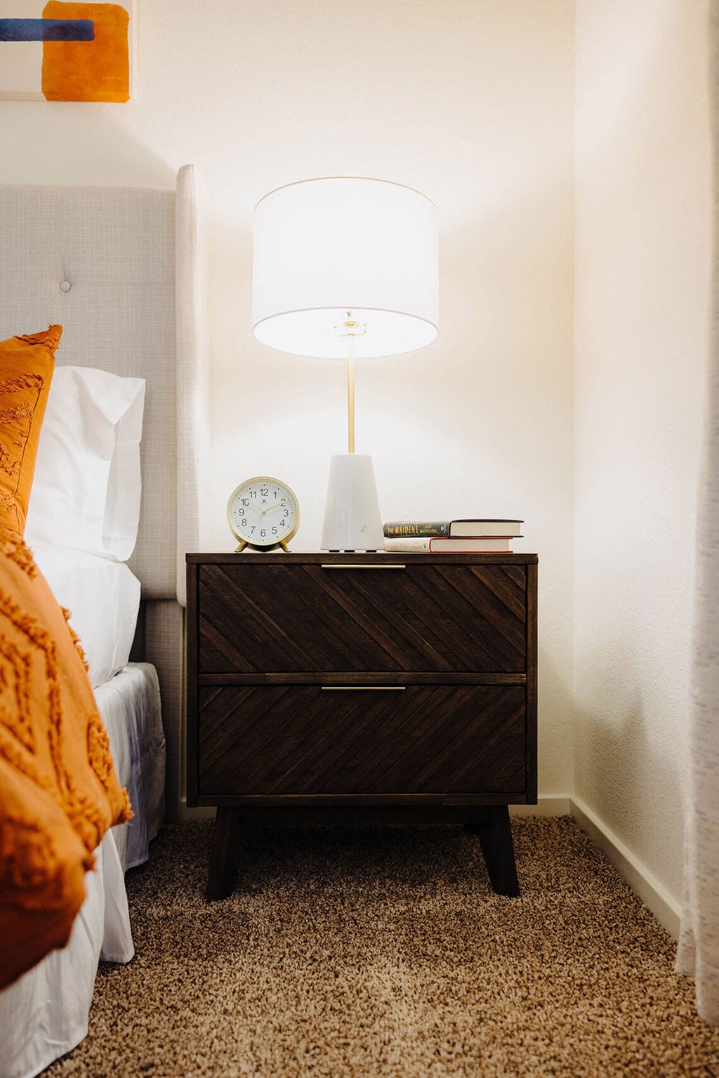 a bedroom with a bed and a nightstand with a clock and a lamp on top of  at Arrive Paso Robles, Paso Robles, CA