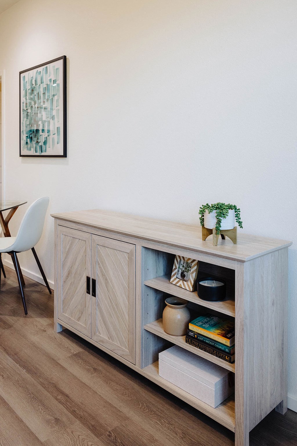 a wooden console table with a plant and books on it at Arrive Paso Robles, California