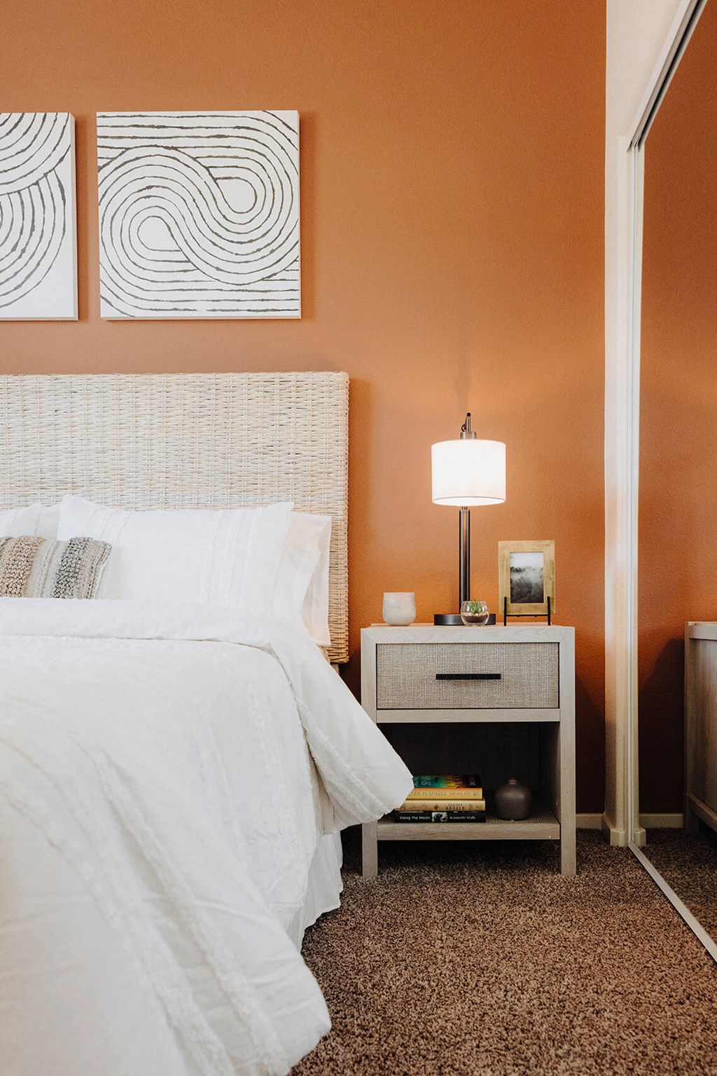 a bedroom with white bedding and a white nightstand with a lamp on top of it  at Arrive Paso Robles, Paso Robles, 93446