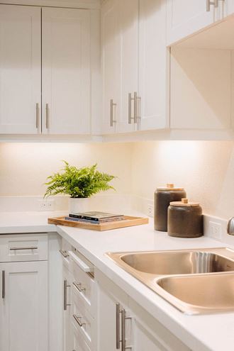 a kitchen with white cabinets and a sink at Arrive Paso Robles, Paso Robles, CA