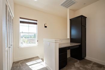 a small kitchen with a counter and a window