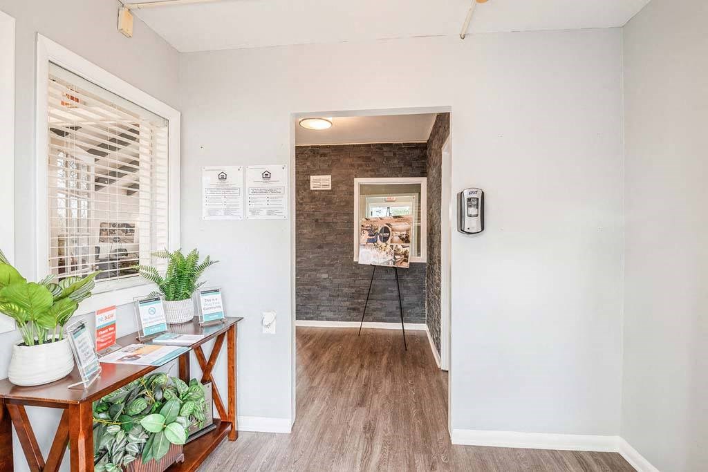 a hallway with a table with plants on it at ReNew Odenton, Odenton, MD, 21113