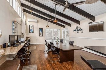 a large room with a wooden floor and a ceiling with exposed beams