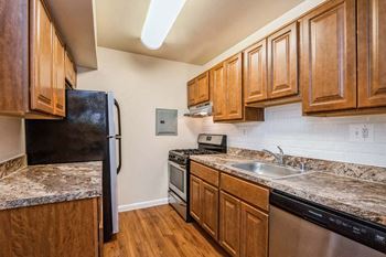 a kitchen with a stove top oven next to a refrigerator