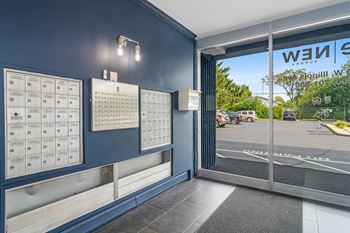 the entrance to a wii game room with a blue wall and a glass door