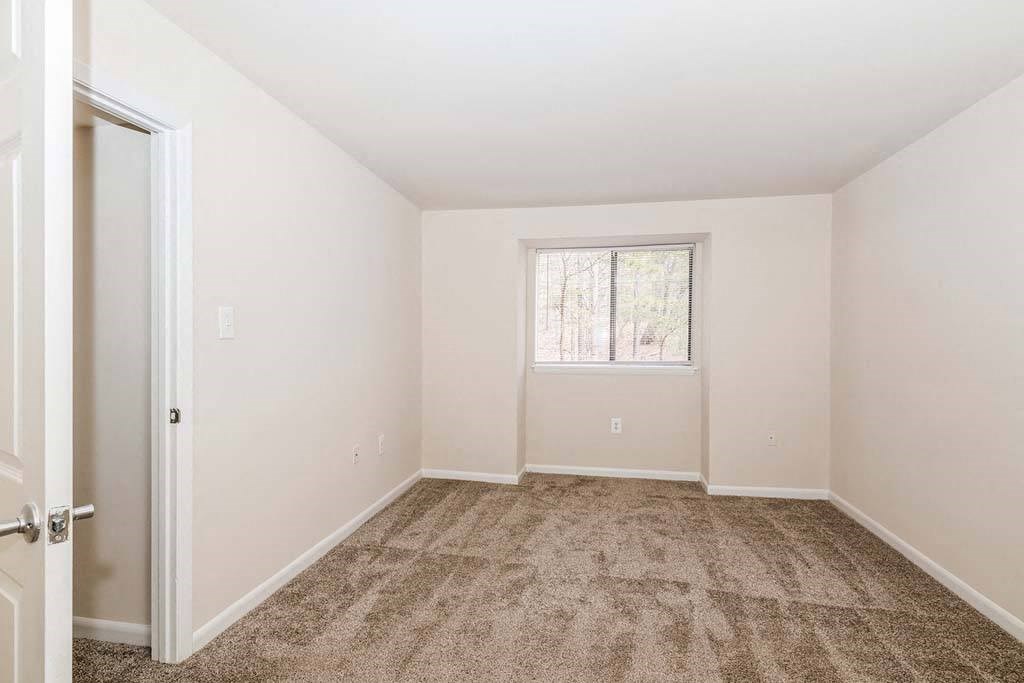 a bedroom with a window and a door at ReNew Odenton, Odenton