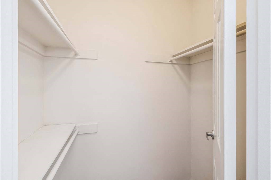 a walk in closet with white walls and white shelves at ReNew Odenton, Odenton, 21113