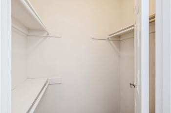 A white closet with a door on the right.