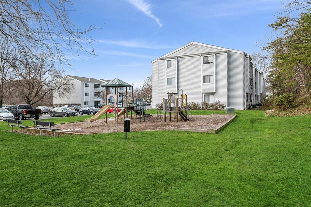a playground with a swing set in the middle of a grassy area at ReNew Odenton, Odenton, Maryland