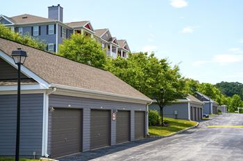 a row of garages with houses in the background