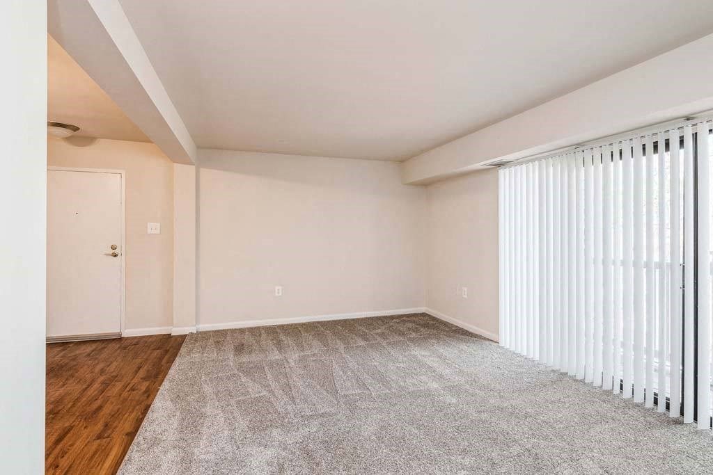 a bedroom with a large window and a door at ReNew Odenton, Odenton, MD, 21113