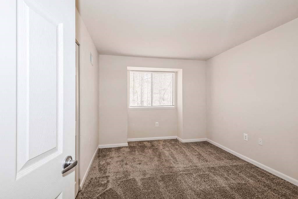 a bedroom with a door and a window at ReNew Odenton, Odenton
