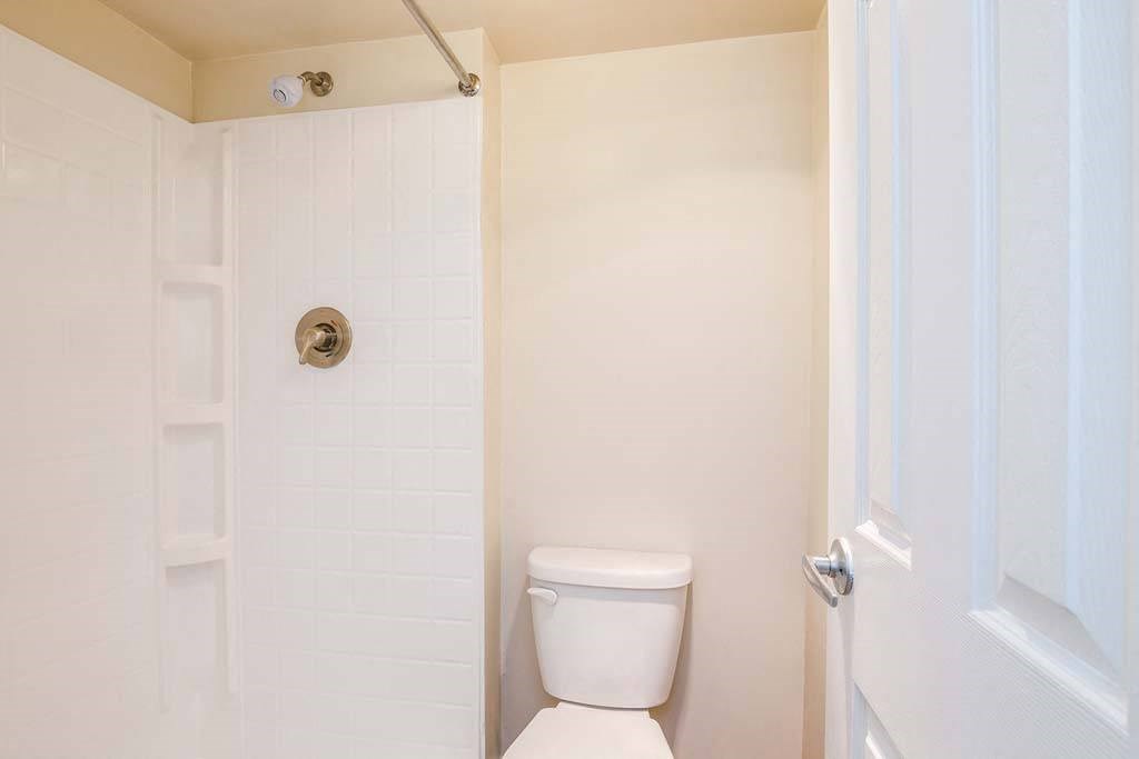 a white toilet sitting in a bathroom next to a shower at ReNew Odenton, Odenton, MD, 21113