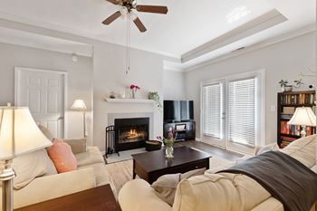 a living room with a couch and a coffee table and a fireplace