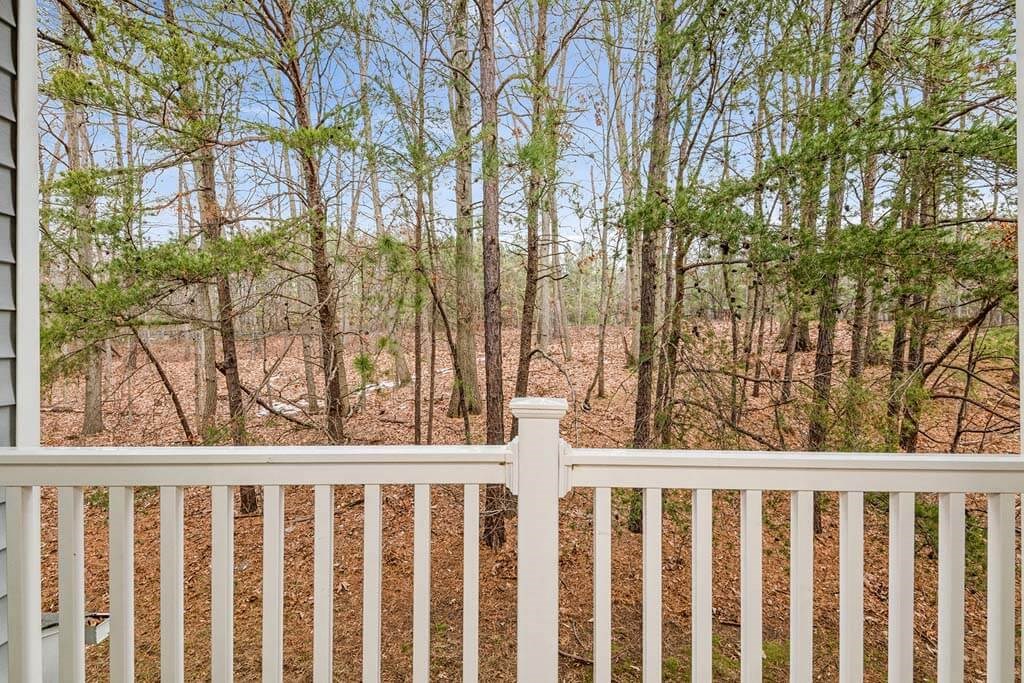 a white fence in front of a wooded area at ReNew Odenton, Maryland, 21113