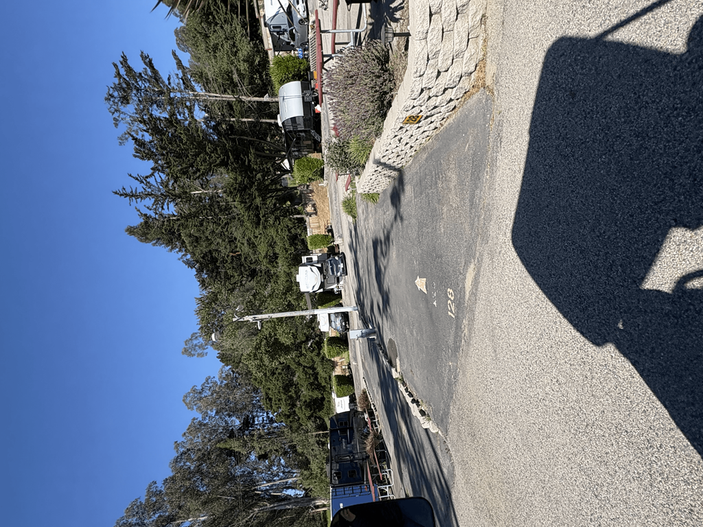 A shadow of a person is cast on the ground.