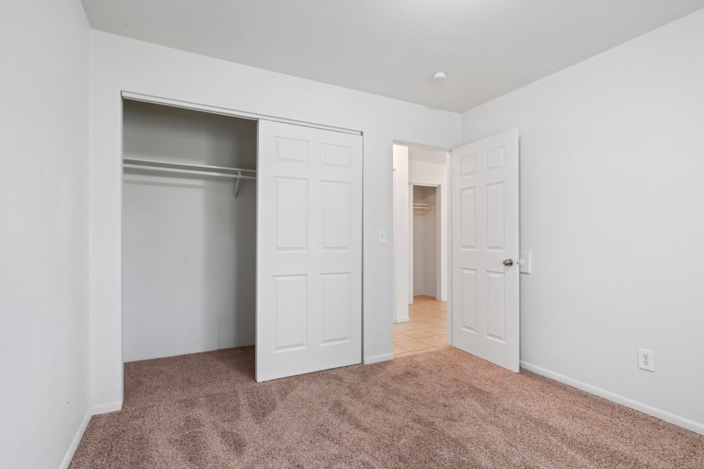 a bedroom with two closets and a carpeted floor at ReNew Eagle River, Alaska, 99577
